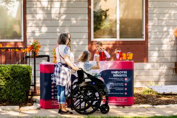 An employee interacting with residents at an event