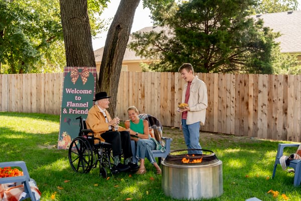 Residents enjoying a community outdoor gathering around a fire pit