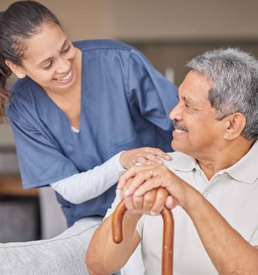 A caregiver interacting with a senior in a comfortable setting