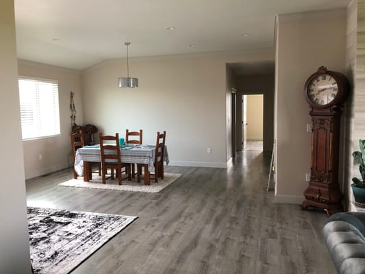 Bright common area with dining table and clock