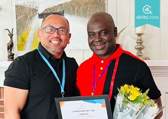 Two caregivers celebrating with an award