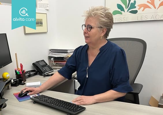 Facility logo with staff member at the reception desk