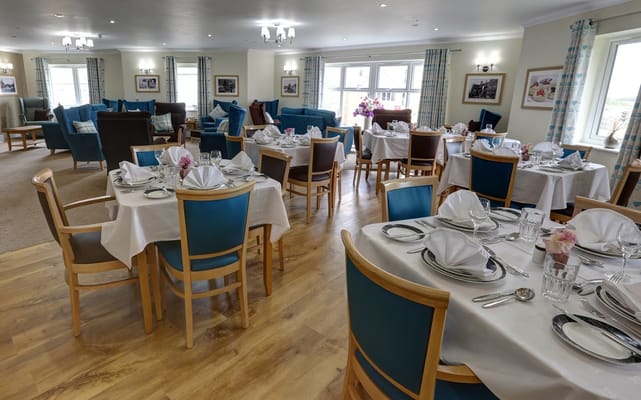 Elegant dining area with set tables and comfortable seating