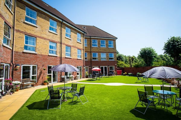 Outdoor space with seating and umbrellas at a senior living facility