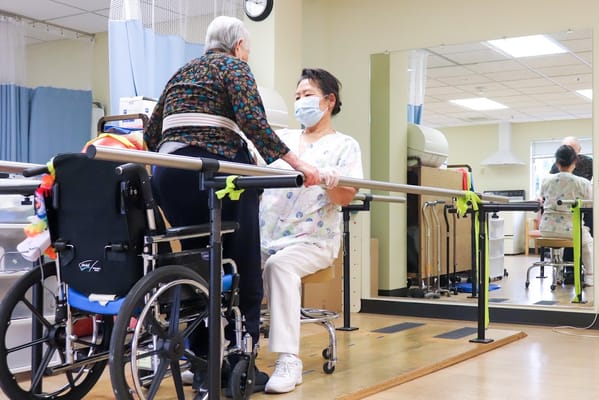 Resident engaging in therapy with staff support.