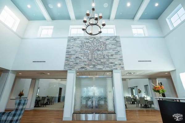 Bright, open common area with a chandelier and water feature