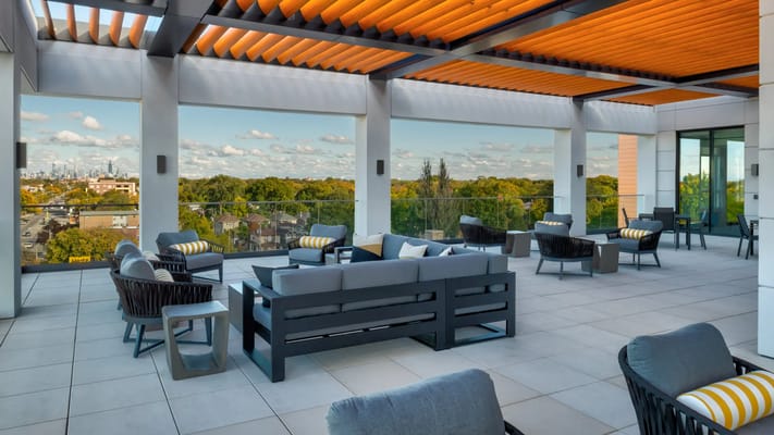 Outdoor lounge area with seating and city view