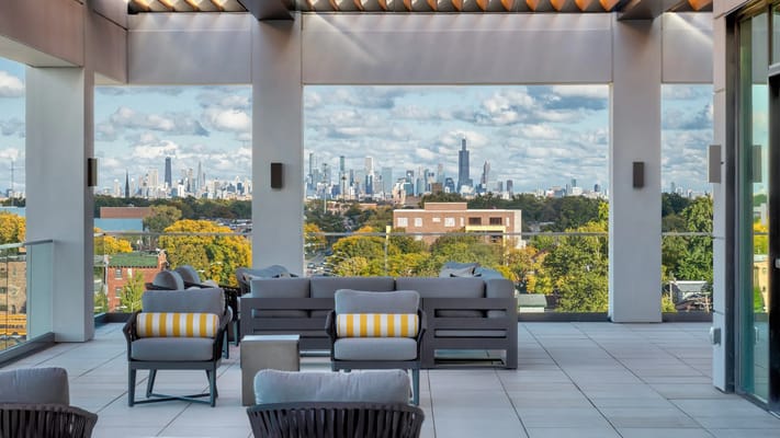Outdoor terrace with seating and city skyline view