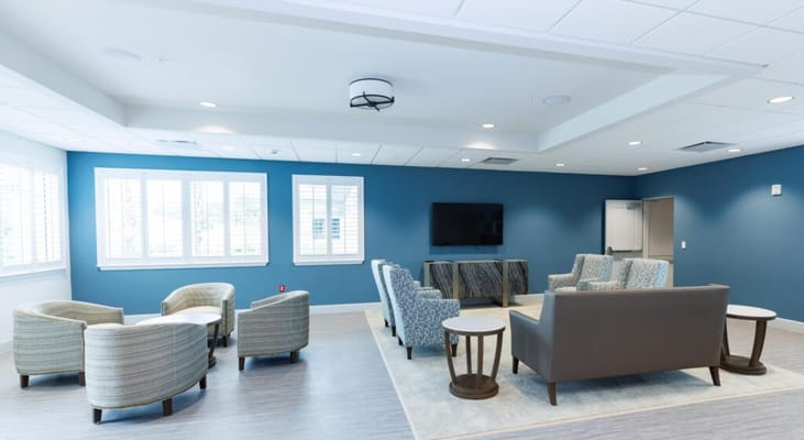 Bright common area with seating and TV