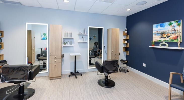 Hair salon area with styling chairs and mirrors