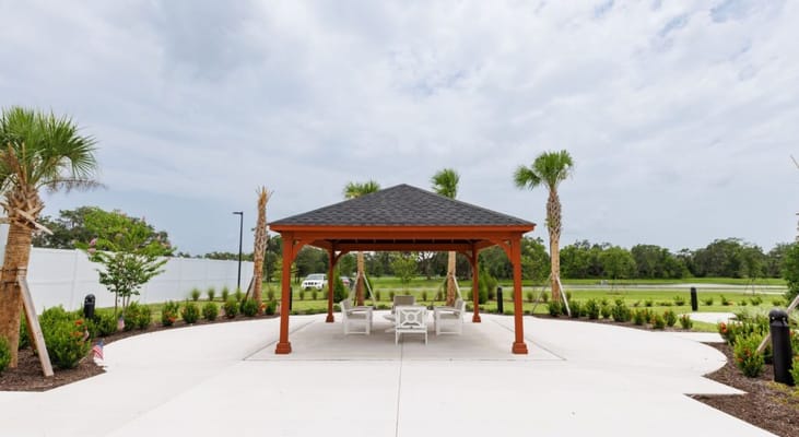 Outdoor gazebo with seating area and landscaping
