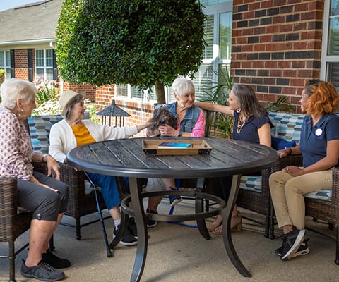 Residents enjoying outdoor time with a pet