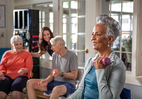 Residents participating in a group exercise class inside