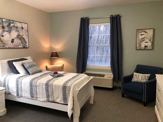 Cozy resident room with bed and armchair