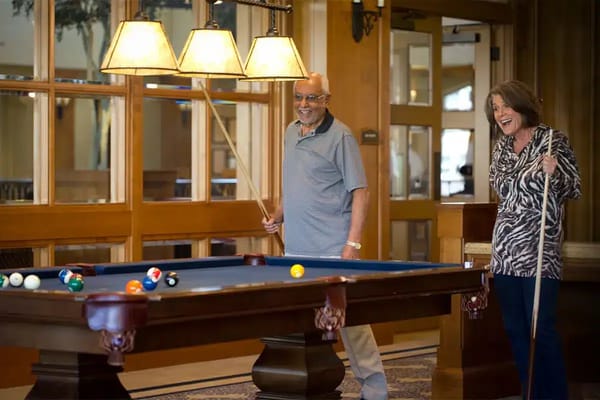 Residents enjoying a game of pool in the common room