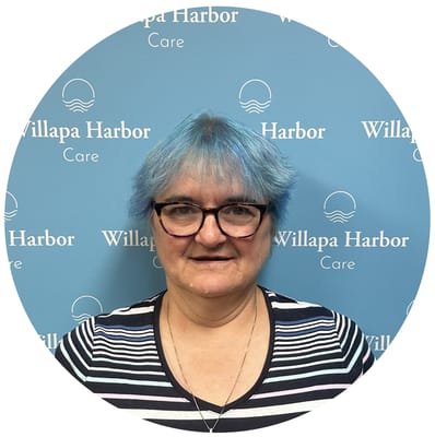 Resident with blue hair posing in front of a backdrop