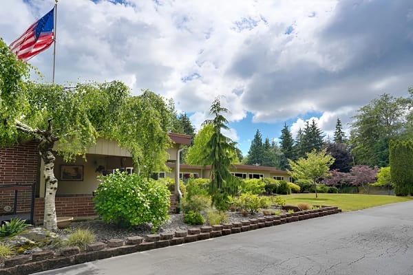 Exterior view of the facility with gardens and trees