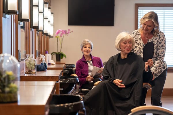 Residents enjoying a beauty salon service in the facility