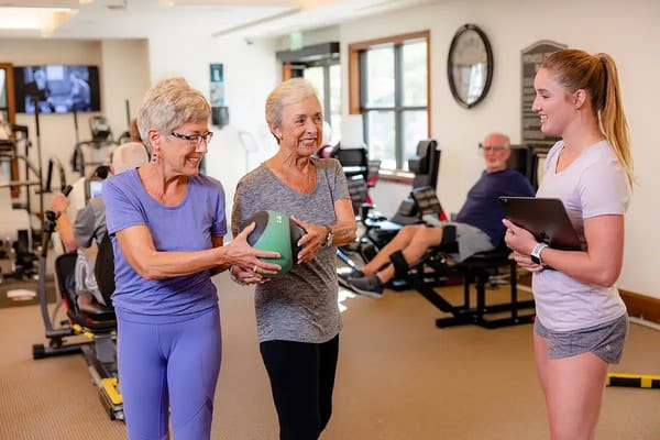 Residents engaging in a fitness class with a trainer