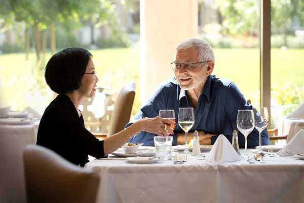 Two residents dining together in a bright restaurant