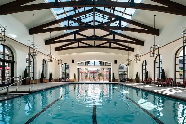 Indoor pool area with large windows and skylights