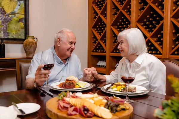 Two residents enjoying a meal together in the dining room