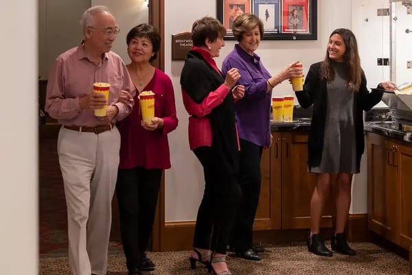 Residents enjoying popcorn at a movie night event