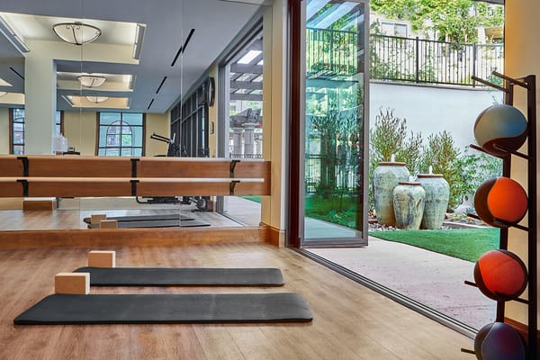 Interior view of a well-lit fitness area with exercise mats