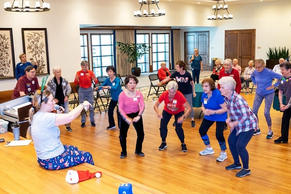 Residents participating in an exercise class in a common area