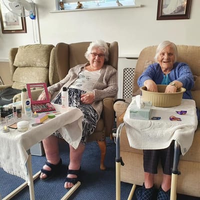 Two residents enjoying a beauty activity in the lounge