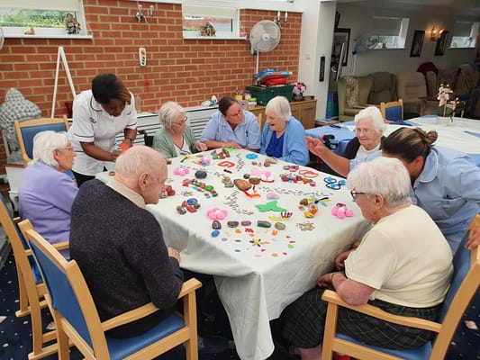 Residents participating in a craft activity in a common area