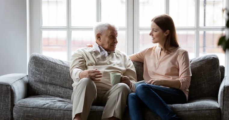 Senior resident engaged in conversation with a caregiver