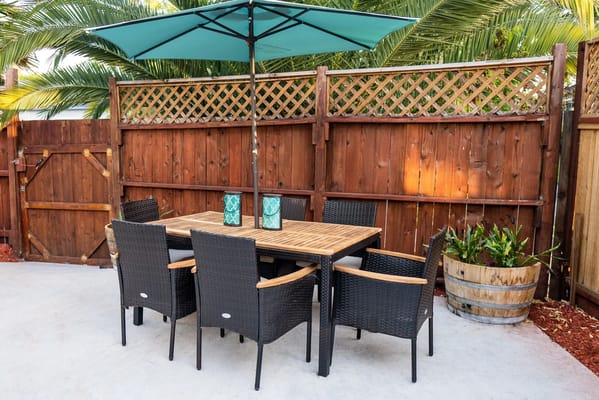 Outdoor seating area with a table and umbrella