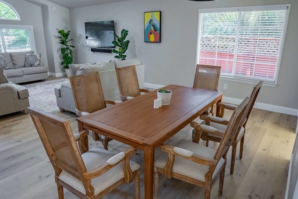 Bright common area with a dining table and chairs