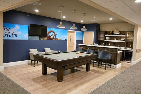 Common area with a pool table and bar seating