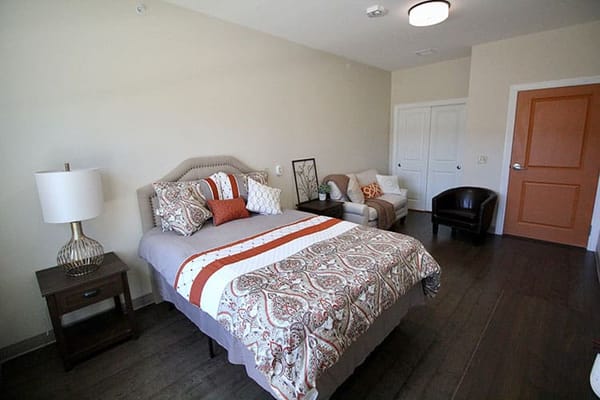 Private resident room with a bed and seating area
