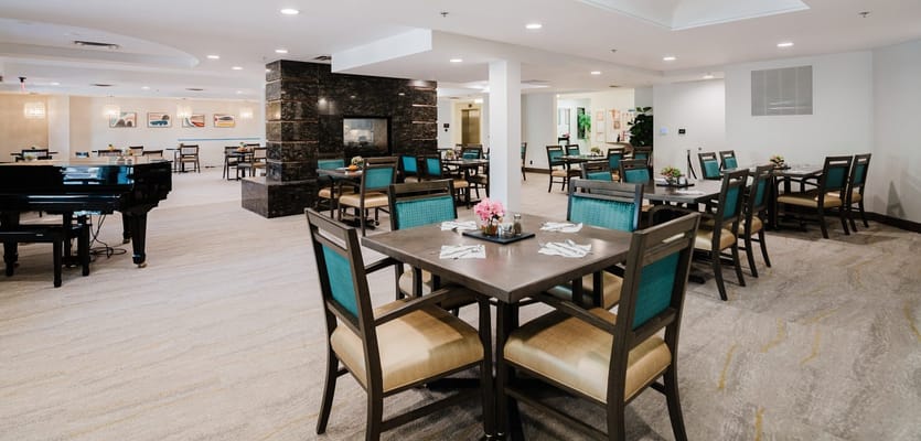Bright dining room with tables and a piano