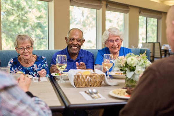 Residents enjoying a meal together in the dining room
