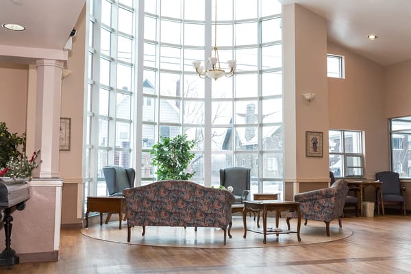 Bright common area with large windows and seating.