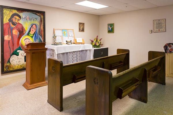 Interior view of a small chapel with pews