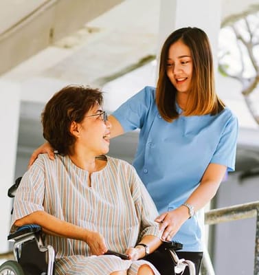 Caregiver interacting with a resident in a wheelchair