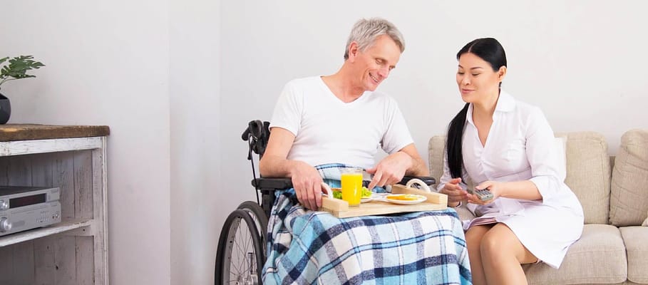 Caregiver assisting a resident with a meal.