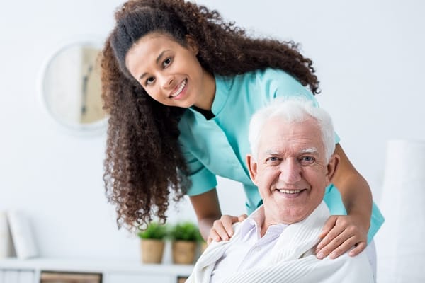 A caregiver with a senior resident in a bright living area