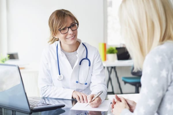 A healthcare professional consulting with a resident