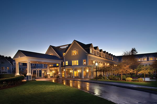 Exterior view of a senior living facility at twilight