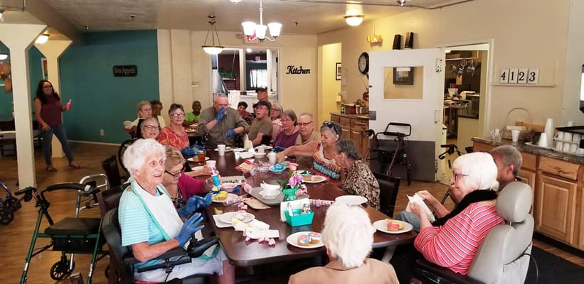 Residents gathering at a dining table enjoying snacks