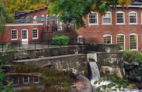 View of the facility building and outdoor area with a water feature