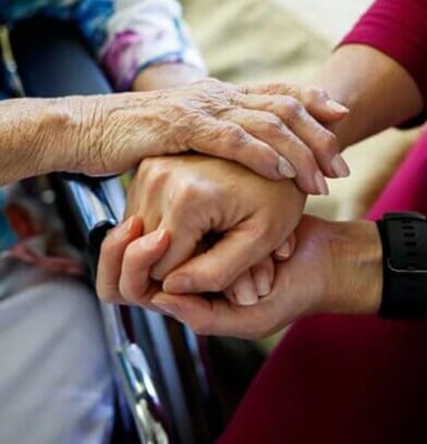Close-up of hands holding in a caring gesture
