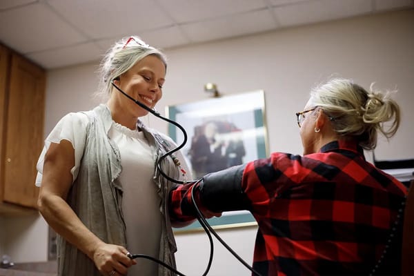 Healthcare staff taking a resident's blood pressure