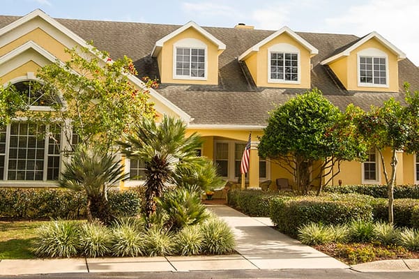 Exterior view of a senior living facility with landscaping